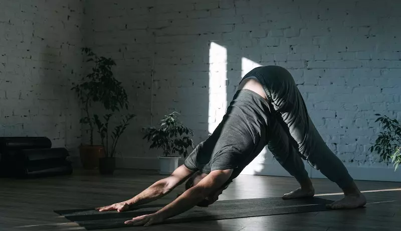 a men doing downward-facing dog yoga asana