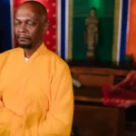 a monk doing meditation while standing