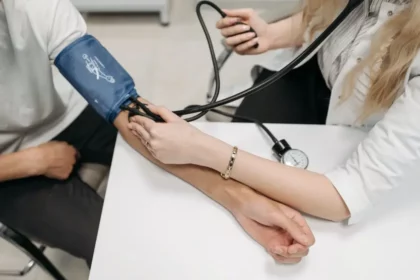 A doctor is measuring a person's blood pressure