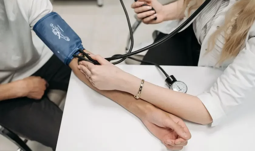 A doctor is measuring a person's blood pressure