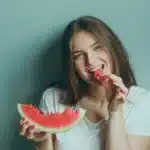 A girl is eating a watermelon