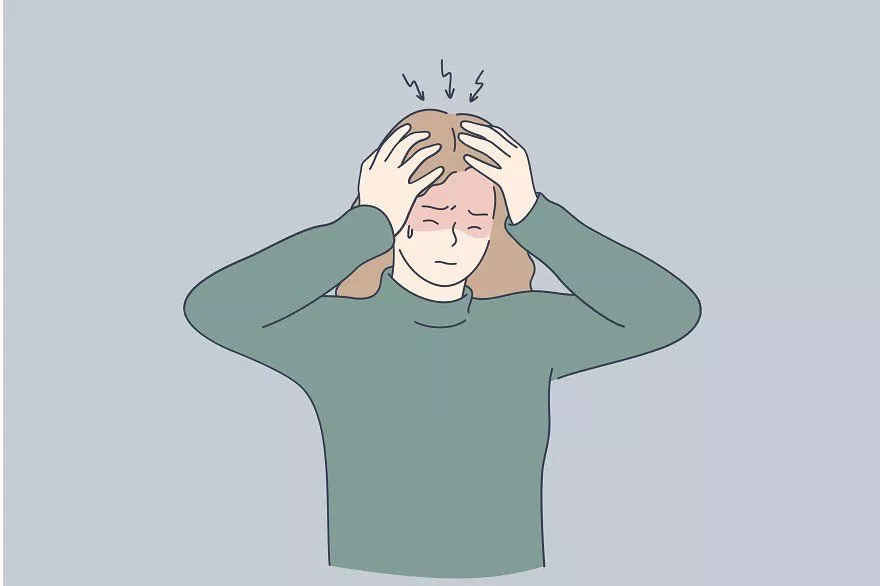 A girl is holding her head because of headache
