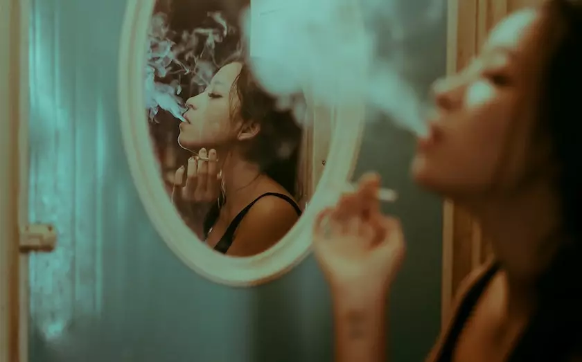 A girl is smoking which is a bad habit