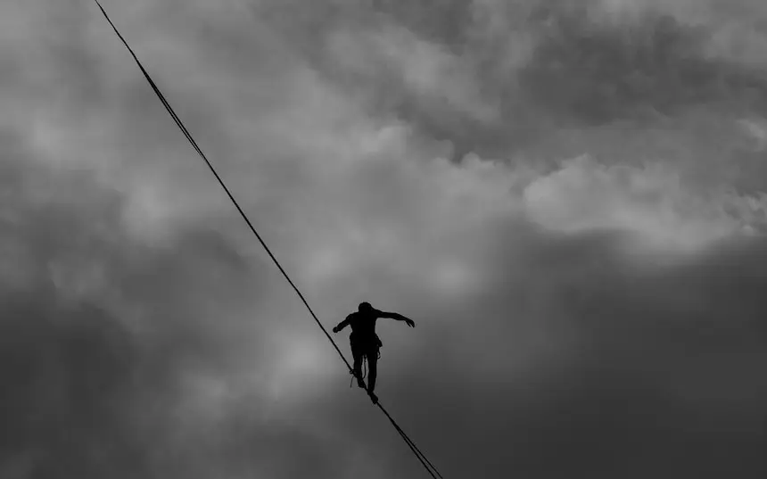 a person is walking on rope