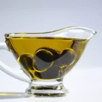 olive oil with olive in a glass pot