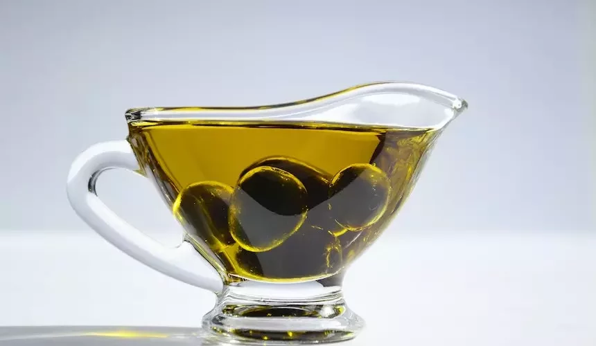 olive oil with olive in a glass pot