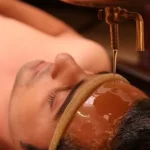 Oil-is-falling-on-a-man-forehead-Shirodhara-therapy
