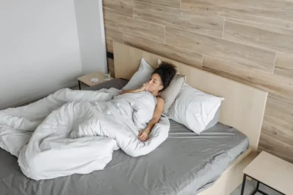 A woman coughing lying in bed