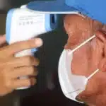doctor checking patient body temperature