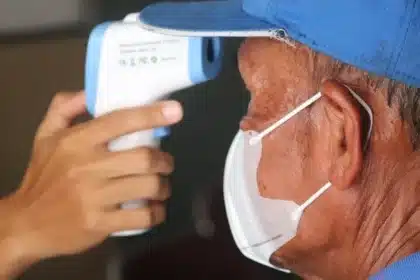 doctor checking patient body temperature