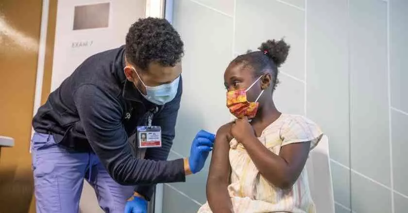 A doctor vaccinating a girl