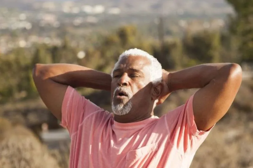 A man puts his hand behind his head Breathing exercise for healthy lungs