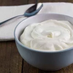 A bowl of yogurt with a spoon