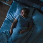 A man is shown sleeping.