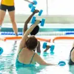 Several women are doing hydrotherapy exercises