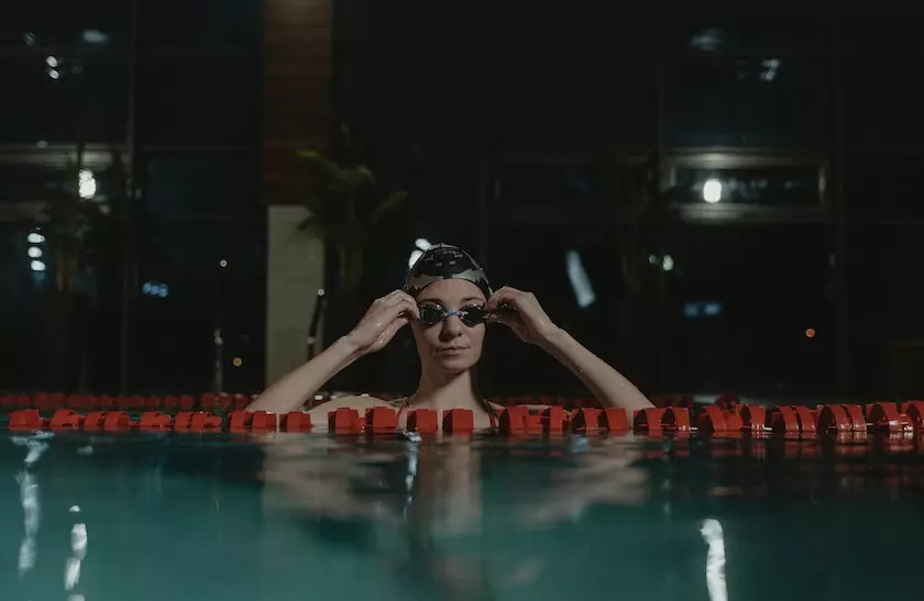 a women touch goggles in the pool